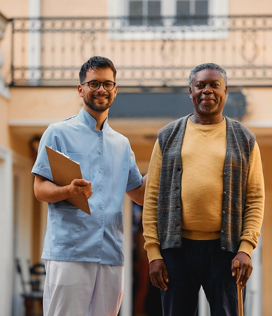 A male and a senior man smiling