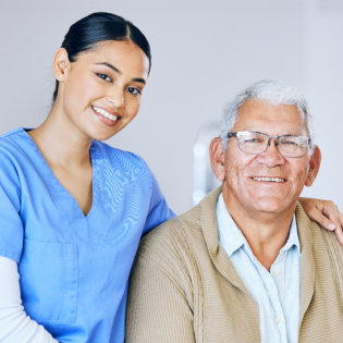 A female caregiver putting her arms to the senior man