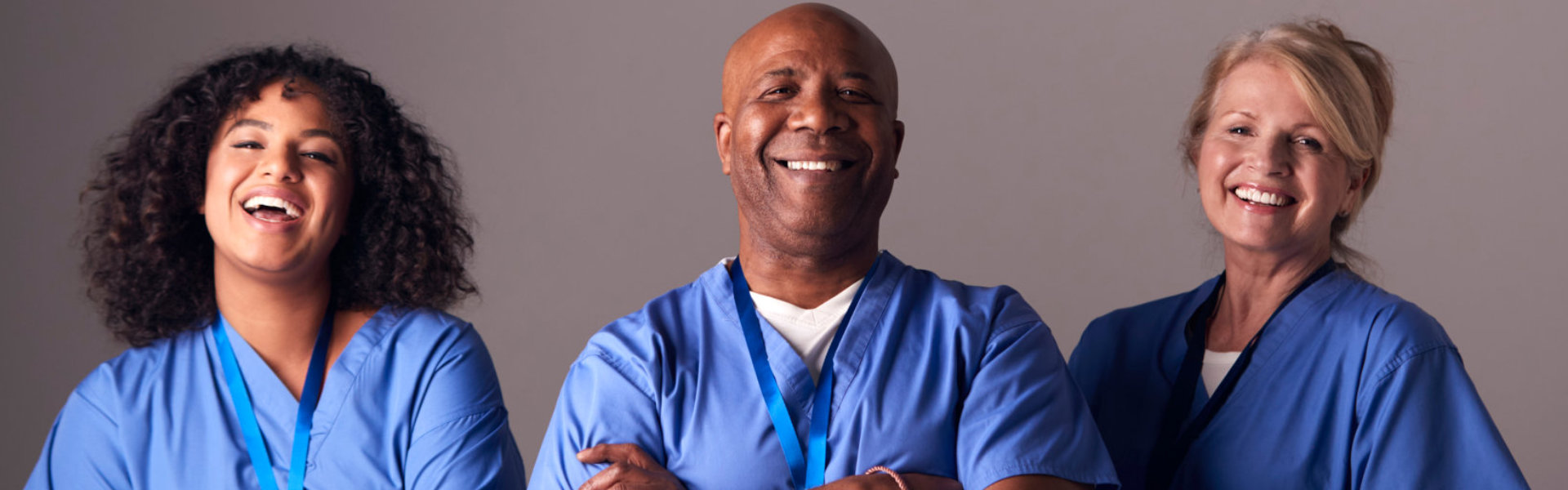 Three caregiver smiling together