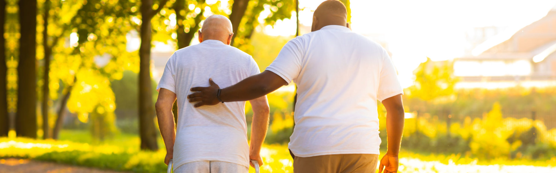 A senior man and a male walking outside