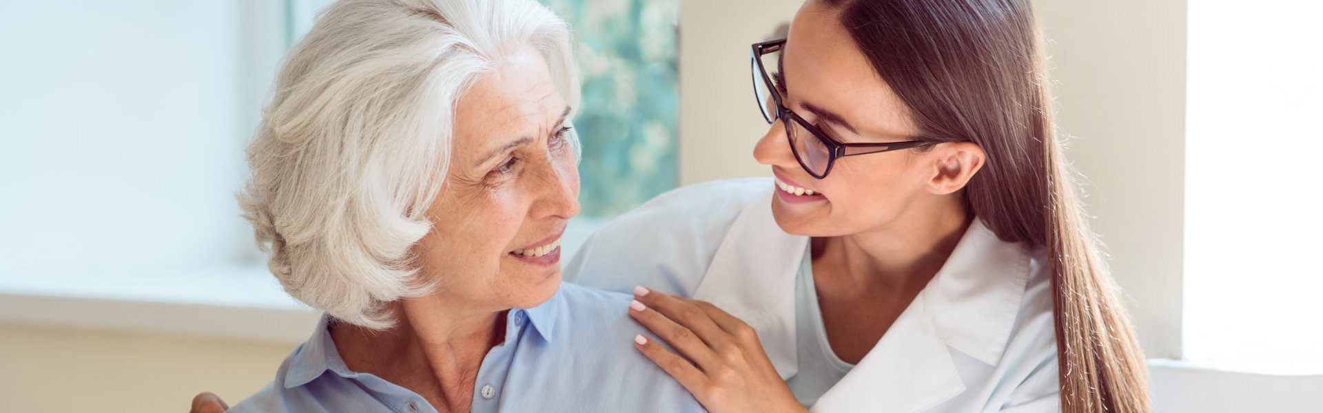 A female and a senior woman looking at each other